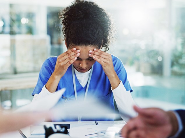 Doctora agobiada por la carga de trabajo.